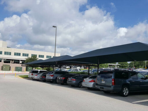 Long covered parking shade structure over a commercial parking lot