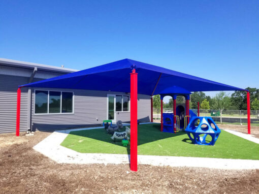 Blue shade structure over a school playground