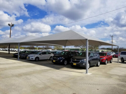 Parking shade structures covering cars at Gunn Automotive in Live Oak, TX