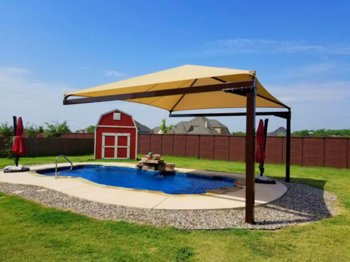 Cantilever shade structure over a backyard pool and patio