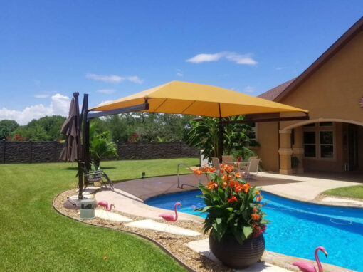 Cantilever shade over a backyard pool and patio