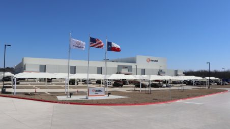 Cantilever outdoor shade structures installed over car wash bays at a commercial facility